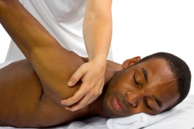 Massage therapy session at Elevate Wellness Chiropractic, focusing on shoulder and upper back relief.