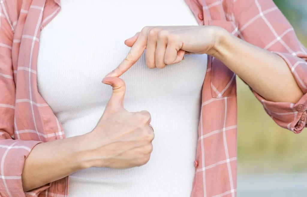 Person demonstrating hypermobility by bending their thumb backward, illustrating excessive joint movement related to chiropractic care for managing hypermobility.